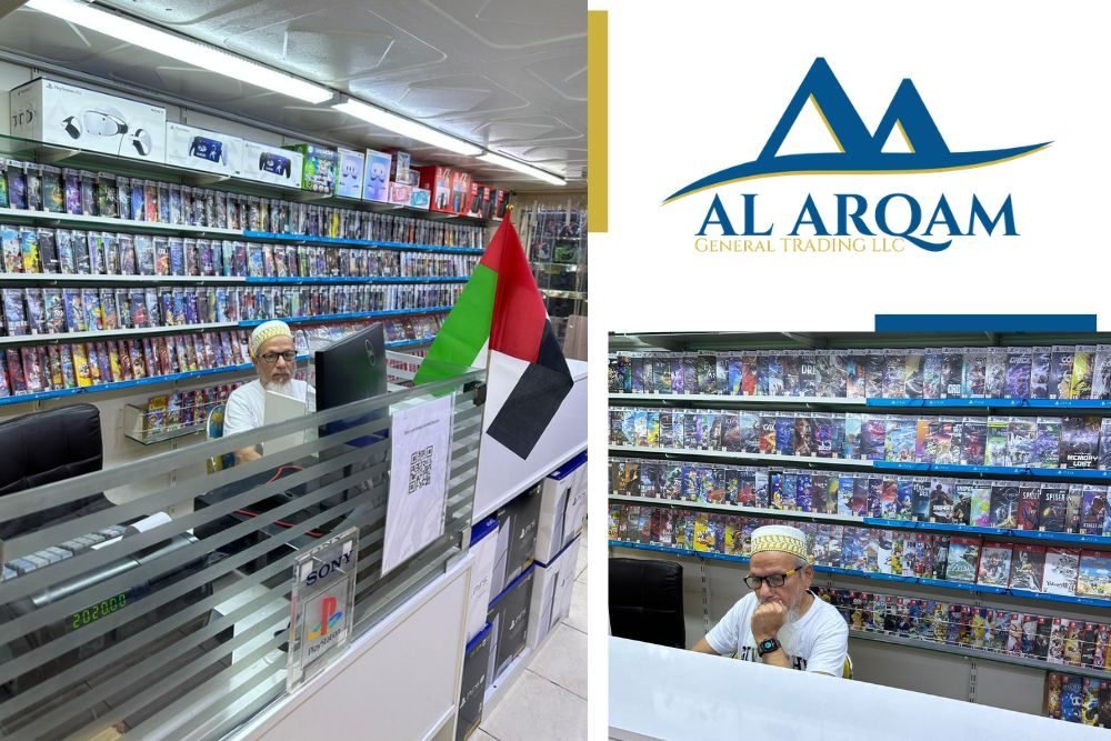 Inside the Al Arqam General Trading store: shelves of PlayStation games and consoles, with the UAE flag at the counter